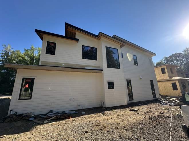 Two story custom home framed with wide window openings