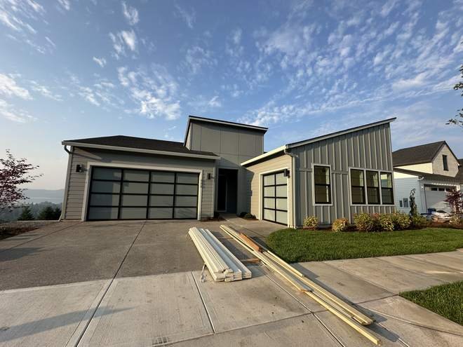 Completed luxury custom home exterior with attached garage