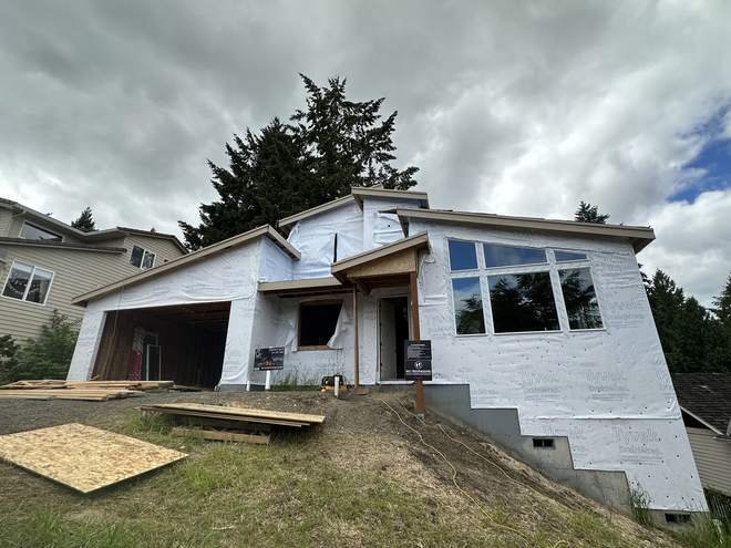 Custom home framed and wrapped on a sloped hillside lot